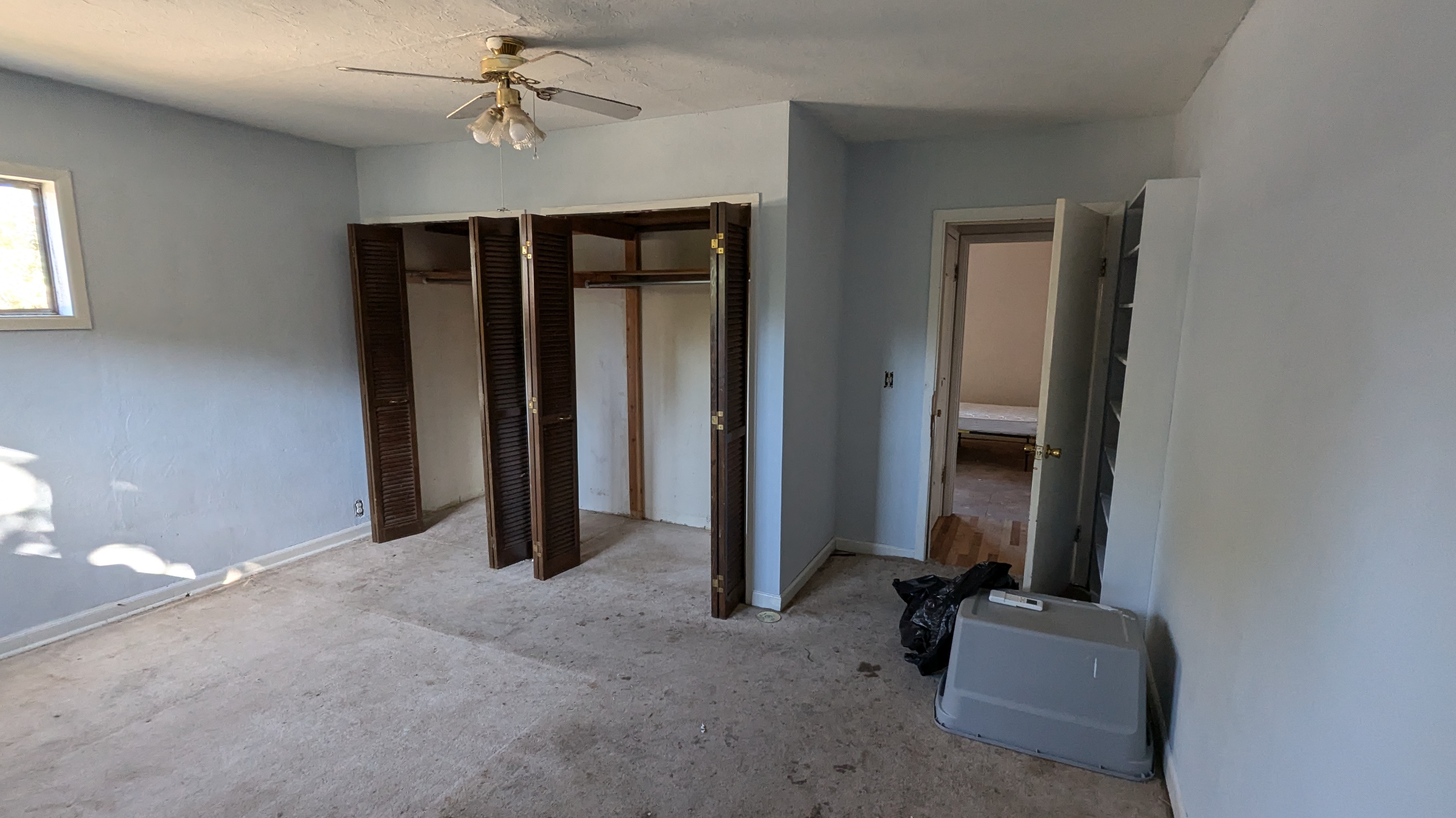 Before remediation and repair of a carpeted primary bedroom
